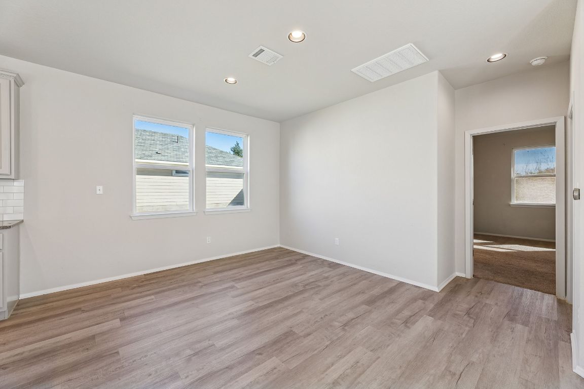 316 Insider Loop Elgin, TX 78621 - Photo 8 of 39 Unfurnished room featuring recessed lighting, light wood-style floors, and healthy amount of natural light