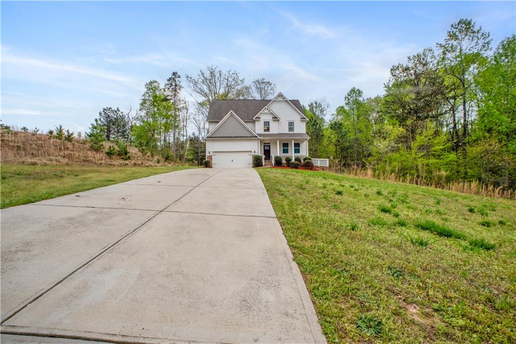 6219 Trojan Drive Gainesville, GA 30506 - Photo 1 of 50 a front view of a house with a yard and trees