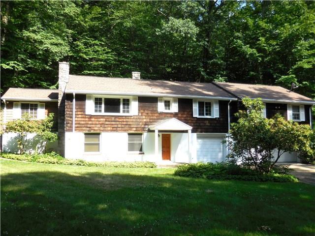 826 Dogburn Road Orange, CT 06477 - Photo 1 of 1 a front view of a house with a yard and green space