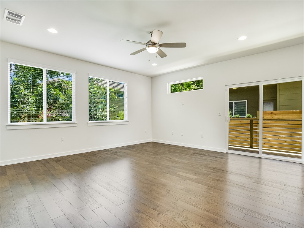 6800 Menchaca Road, Unit 39 Austin, TX 78745 - Photo 4 of 16 Rich wood floors and abundant natural light create an inviting atmosphere in this open space.