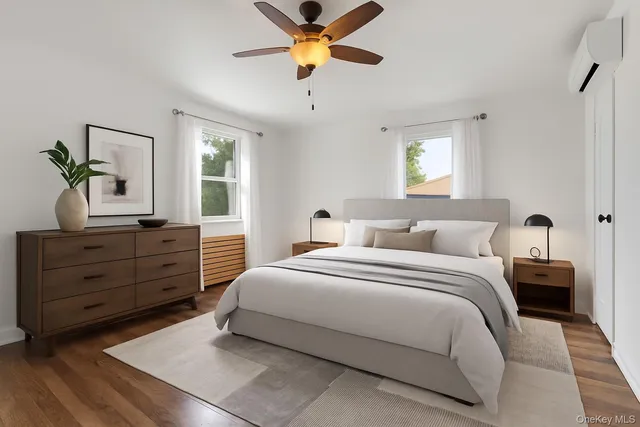 a bedroom with a bed dresser and a window