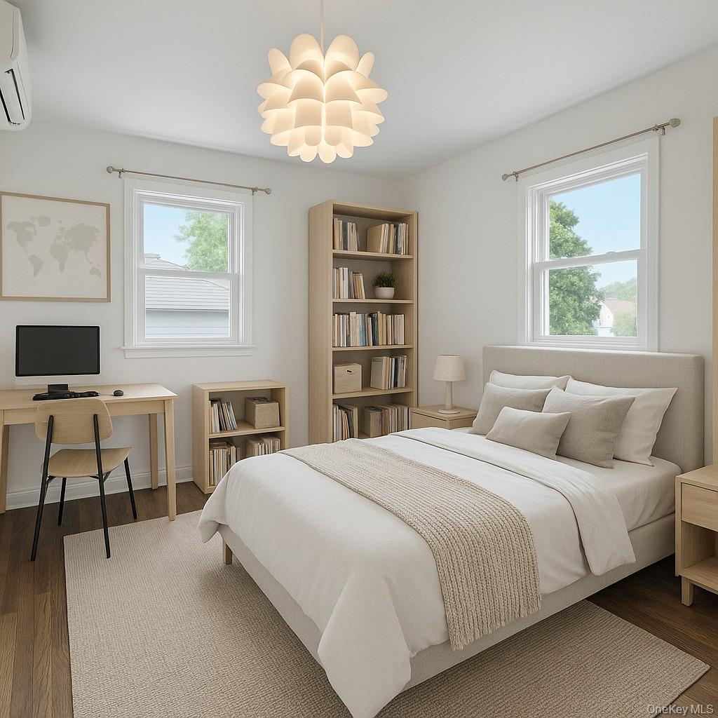 79-31 211th Street Queens, NY 11364 - Photo 16 of 28 Bedroom with wood finished floors, multiple windows, and an office area