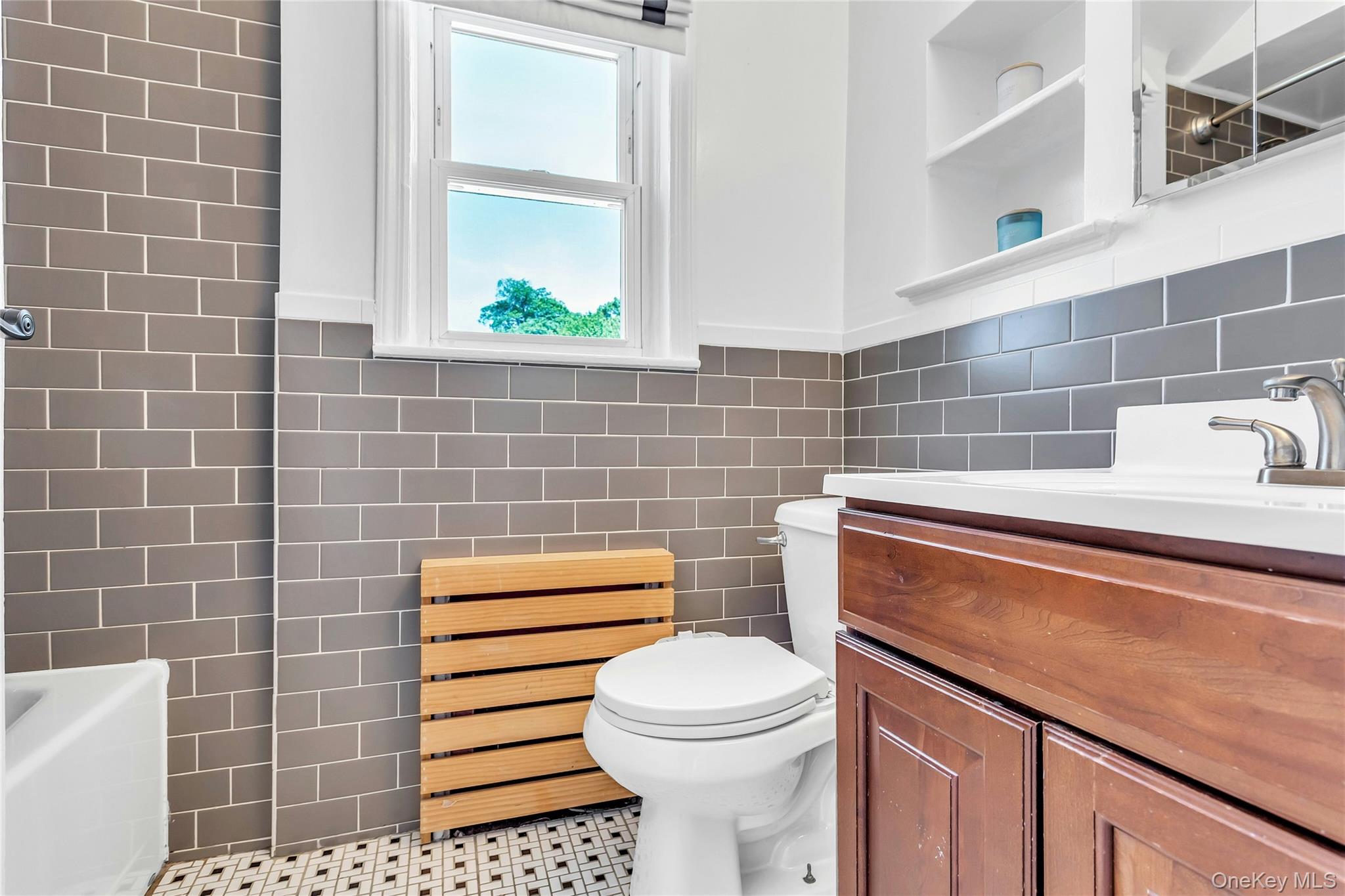 79-31 211th Street Queens, NY 11364 - Photo 18 of 28 Full bathroom featuring tile walls, vanity, toilet, a bathtub, and a shower
