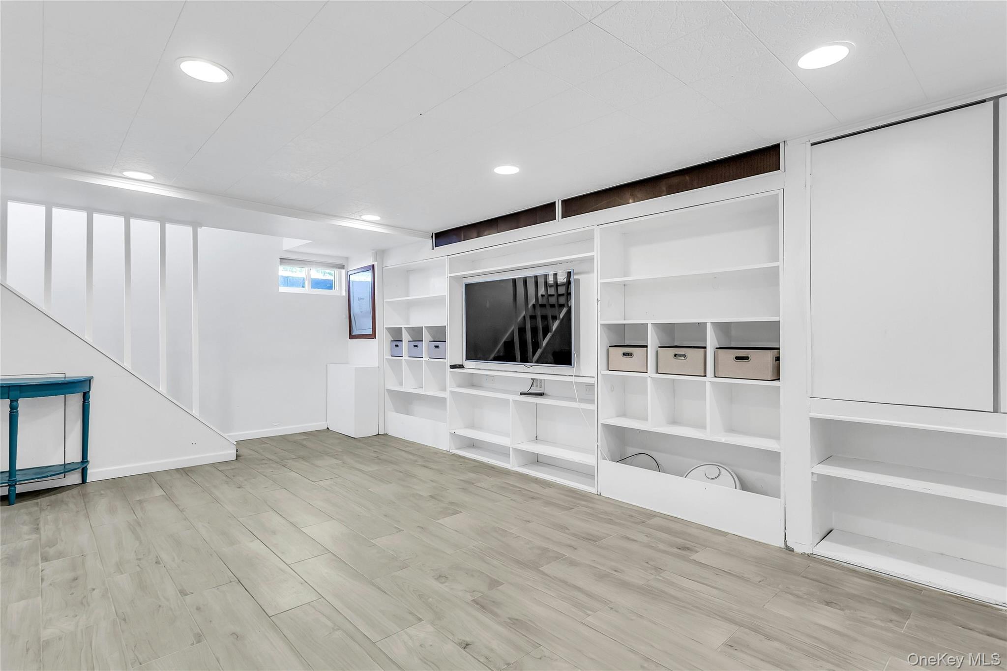 79-31 211th Street Queens, NY 11364 - Photo 20 of 28 Unfurnished living room featuring recessed lighting, wood finished floors, and baseboards