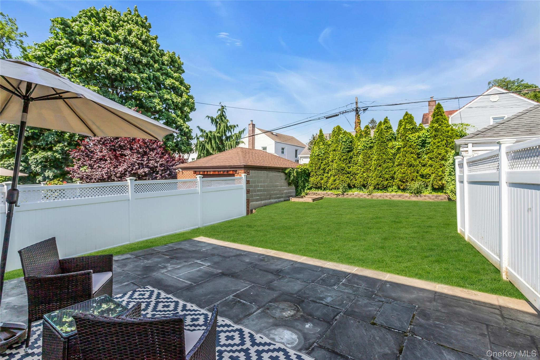 79-31 211th Street Queens, NY 11364 - Photo 25 of 28 Backyard with patio and lawn