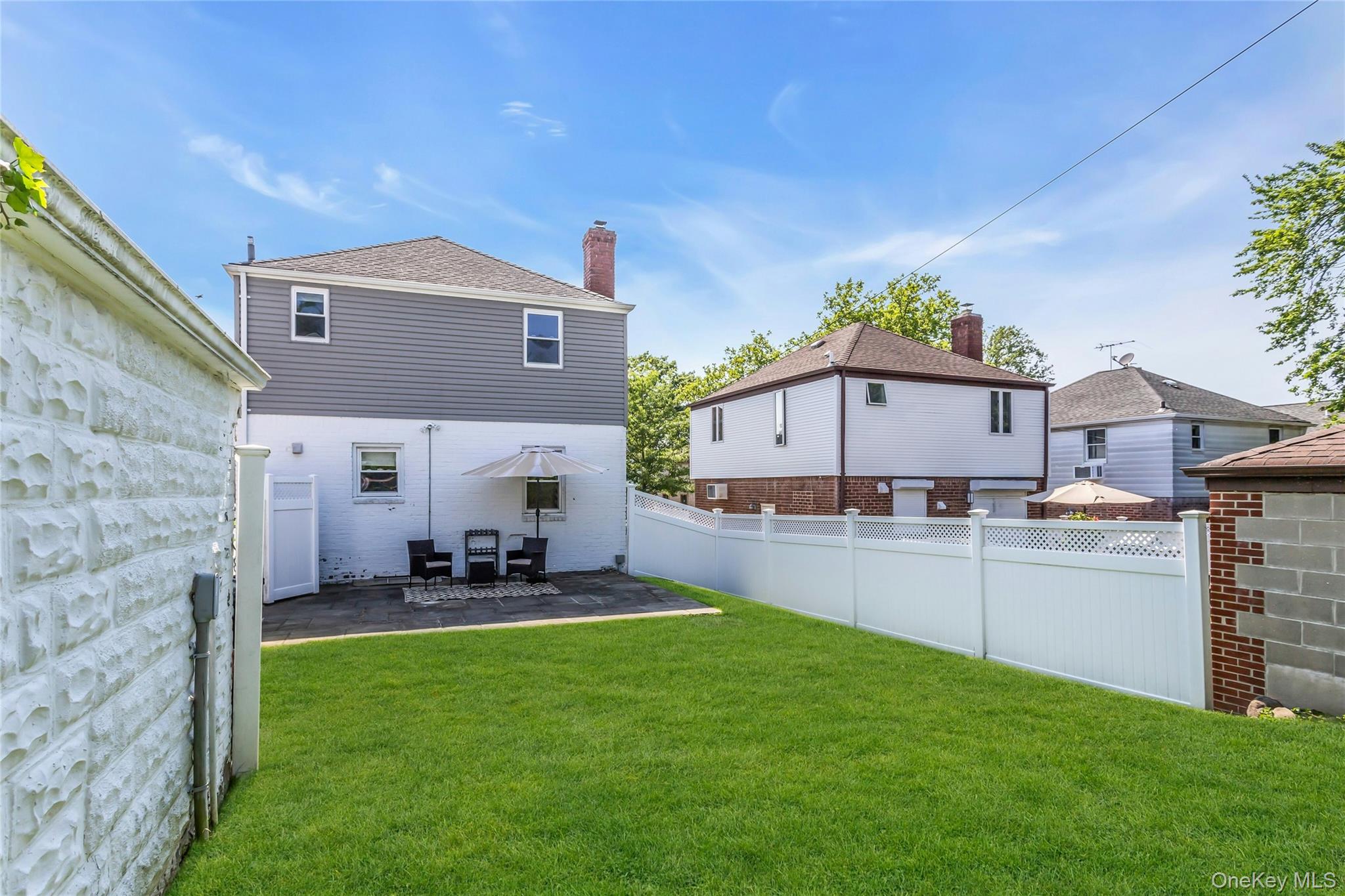 79-31 211th Street Queens, NY 11364 - Photo 26 of 28 Rear view of house with a patio area