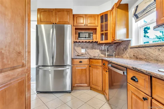 a kitchen with stainless steel appliances granite countertop a refrigerator and a sink