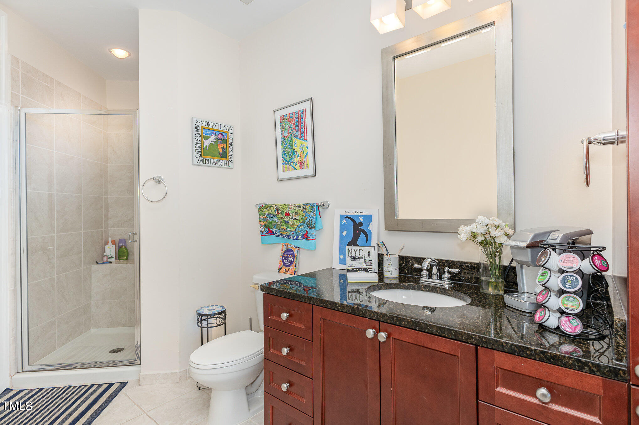301 Fayetteville Street, Unit 2701 Raleigh, NC 27601 - Photo 14 of 26 a bathroom with a granite countertop sink a toilet and a mirror
