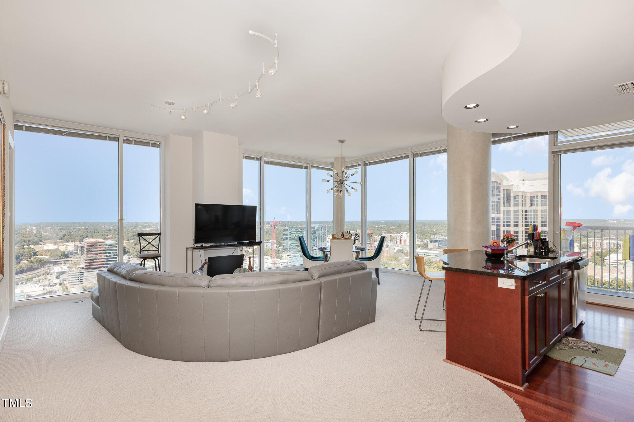 301 Fayetteville Street, Unit 2701 Raleigh, NC 27601 - Photo 2 of 26 a living room with furniture and large windows