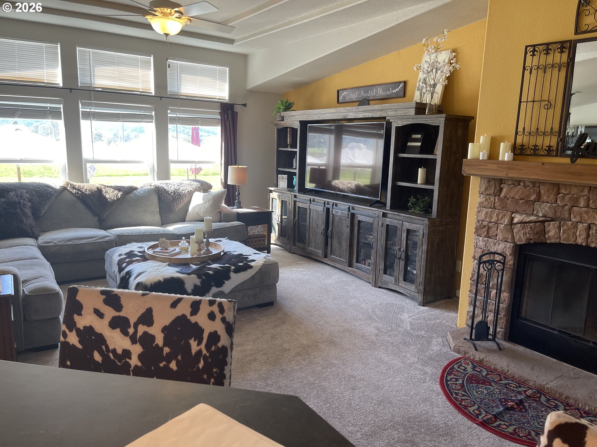 6404 Lookingglass Road Roseburg, OR 97471 - Photo 9 of 48 a living room with furniture a flat screen tv and a fireplace