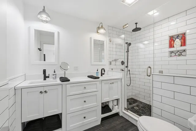 a bathroom with a toilet sink and mirror