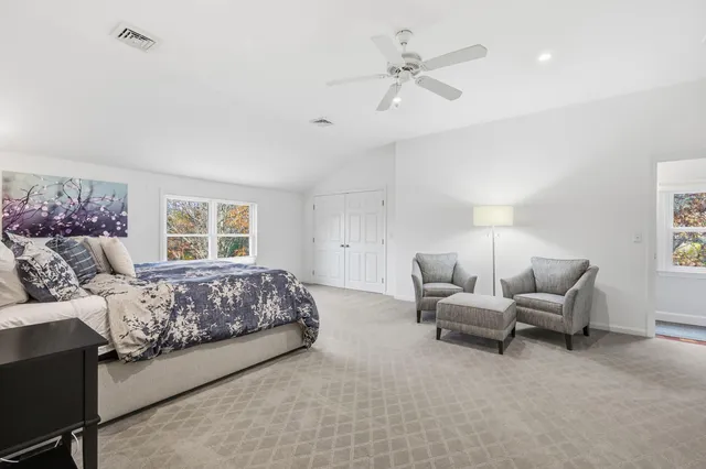 a bedroom with a bed and a refrigerator