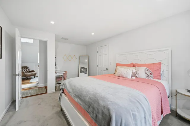 a bedroom with a bed and a chair