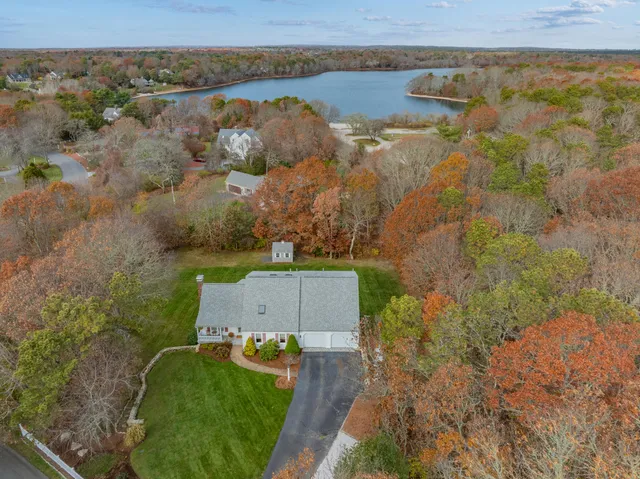 an aerial view of a house with a yard