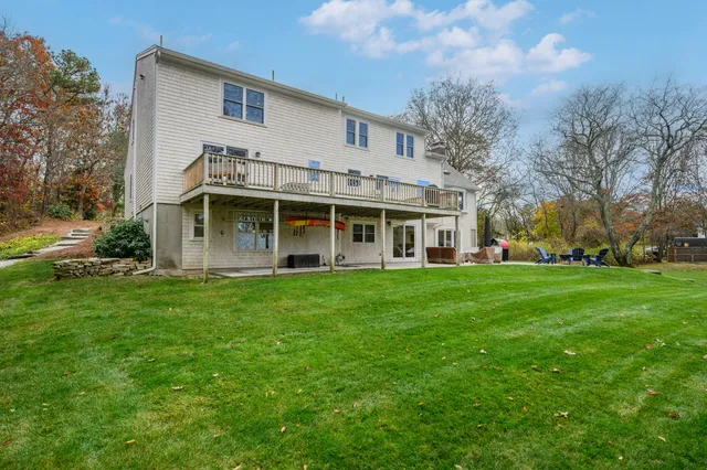 a view of a house with backyard sitting area and porch