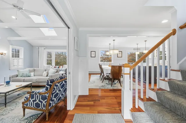 a living room with furniture and a table with wooden floor