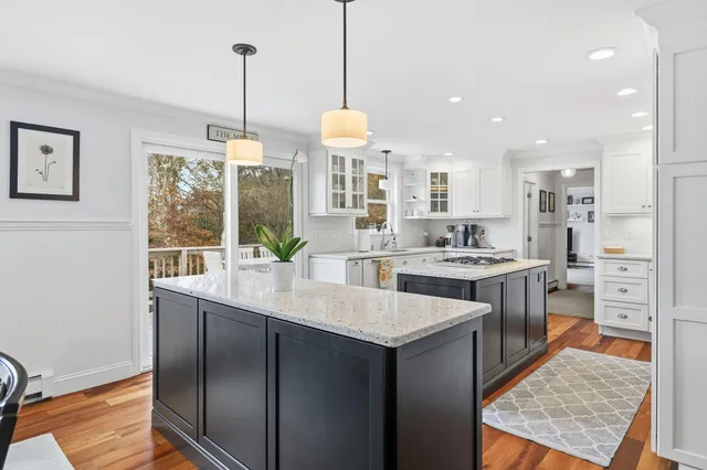 a kitchen with stainless steel appliances granite countertop a sink a stove and a refrigerator