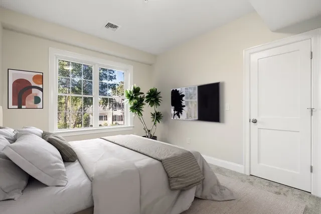 a bedroom with a bed and a large window