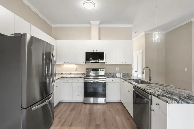 a kitchen with a sink stove and refrigerator