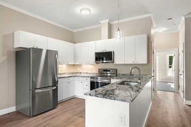 a kitchen with a refrigerator stove and sink