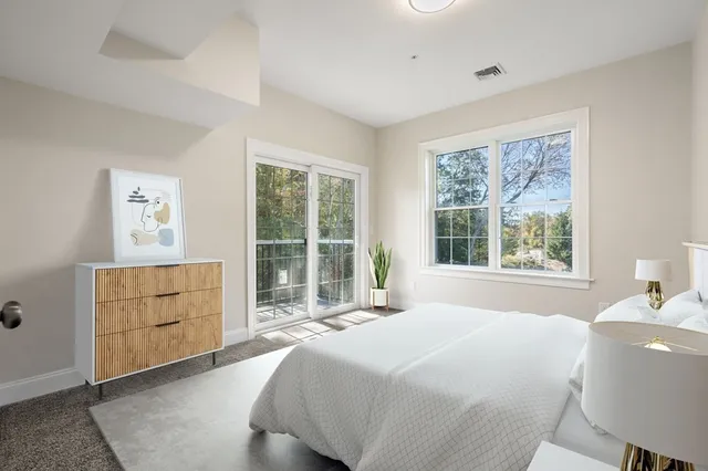 a spacious bedroom with a bed and a window