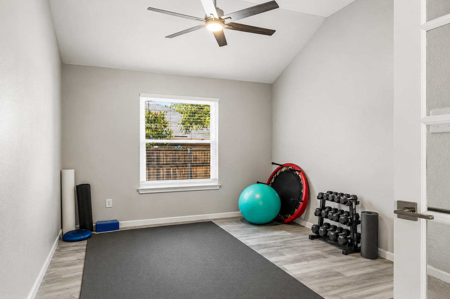 Vaulted ceilings and wood-look flooring define this versatile bonus room with outdoor views. Virtually Staged.