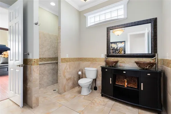 a bathroom with a toilet a sink and mirror