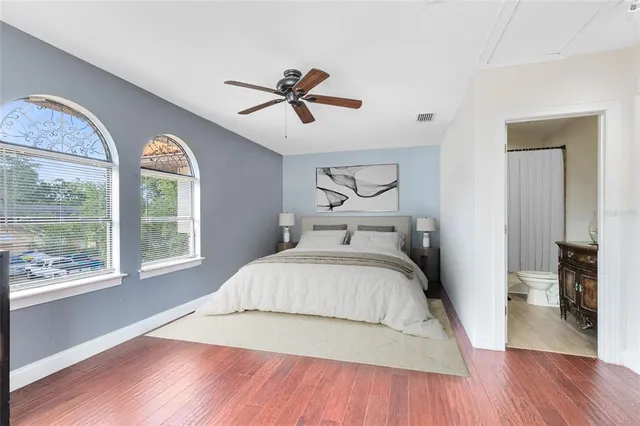 a bedroom with a large bed and a large window