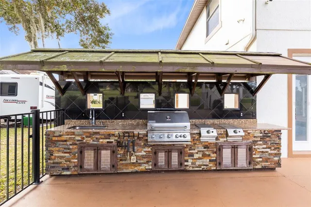 a room with stainless steel appliances and wooden cabinets