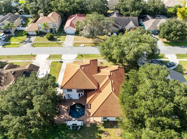 an aerial view of residential houses with yard