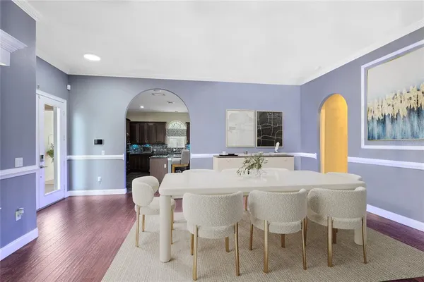 a view of a dining room with furniture and wooden floor