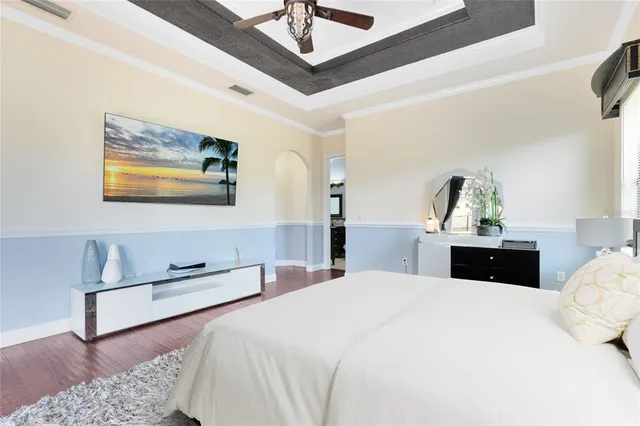 a bedroom with a bed and a chandelier