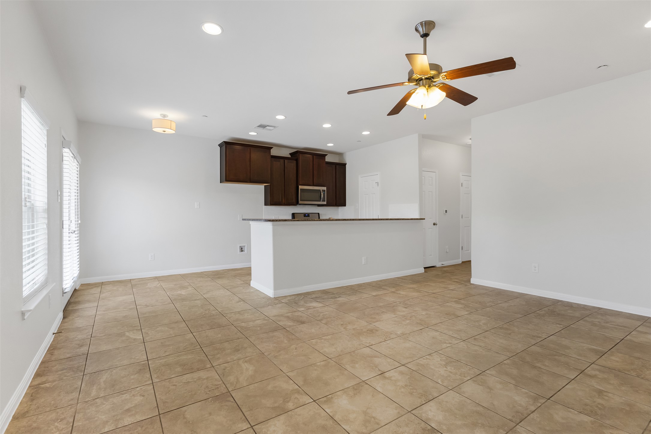 1510 Catalan Road, Unit 602 Austin, TX 78748 - Photo 8 of 36 Unfurnished living room featuring ceiling fan, healthy amount of natural light, recessed lighting, and light tile patterned floors