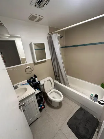a bathroom with a sink a toilet a mirror and shower
