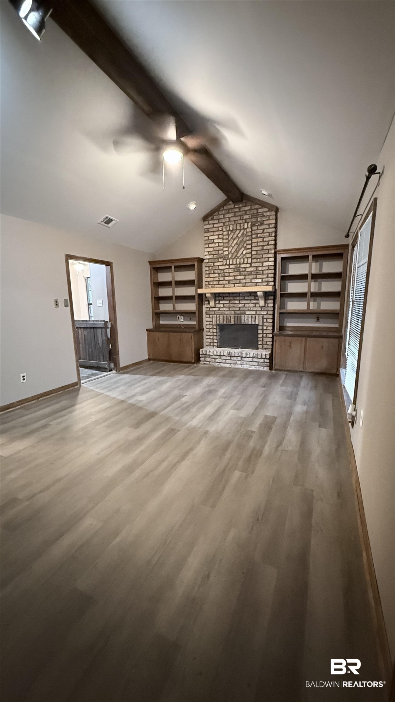 4131 Springdale Road Mobile, AL 36609 - Photo 25 of 28 Unfurnished living room featuring a brick fireplace, light wood-type flooring, and ceiling fan