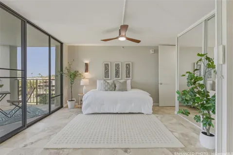 a bed room with a large bed and a chandelier