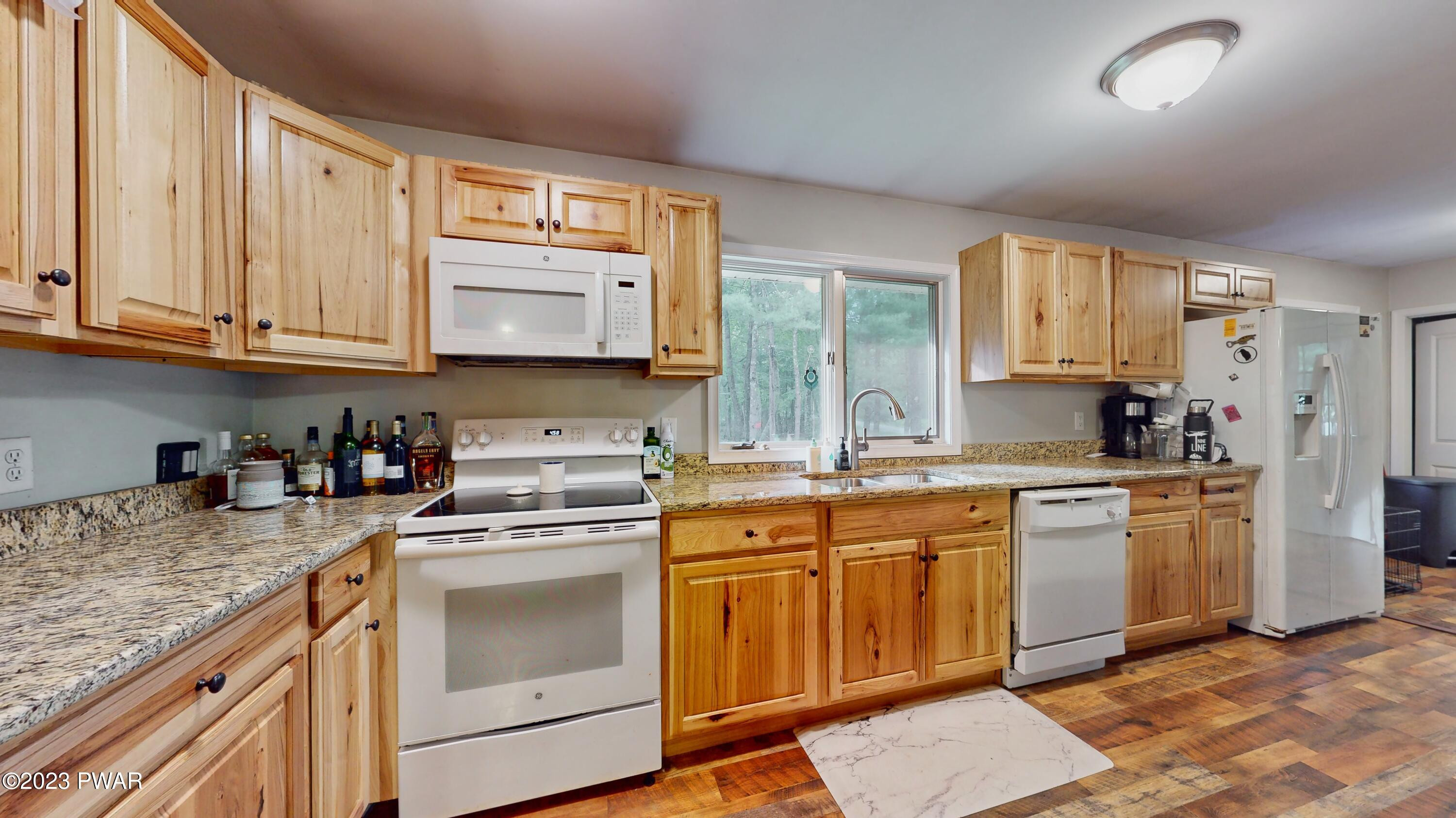 149 Walker Lake Road Shohola, PA 18458 - Photo 2 of 51 a kitchen with stainless steel appliances granite countertop a stove sink and cabinets