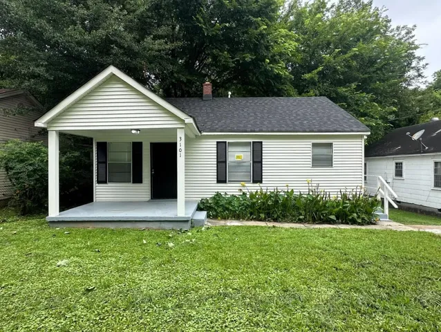 a view of house with yard and green space
