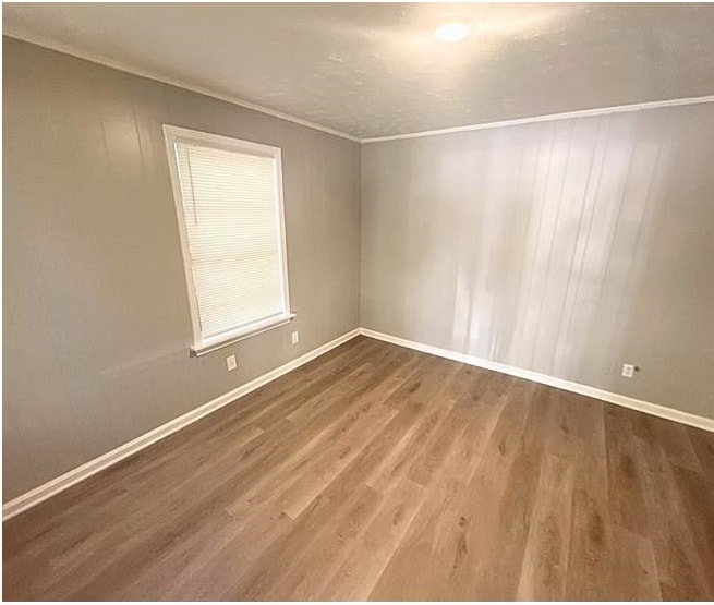 3101 Sunrise Street Memphis, TN 38127 - Photo 2 of 7 a view of an empty room with wooden floor and a window