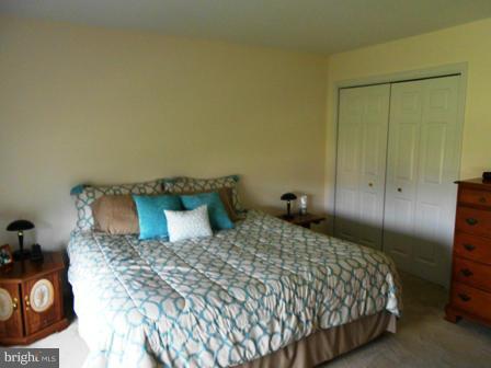26 Robelei Drive Ranson, WV 25438 - Photo 7 of 18 a bedroom with a bed and a table in it