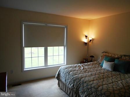 26 Robelei Drive Ranson, WV 25438 - Photo 10 of 18 a bedroom with a bed and a window