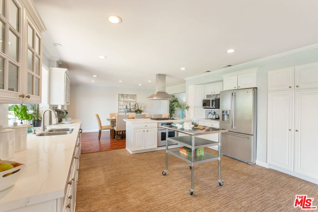 2829 Bottlebrush Drive Los Angeles, CA 90077 - Photo 11 of 40 a kitchen with refrigerator and chairs