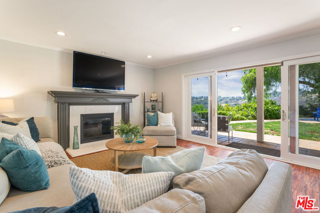 2829 Bottlebrush Drive Los Angeles, CA 90077 - Photo 12 of 40 a living room with furniture fireplace and flat screen tv