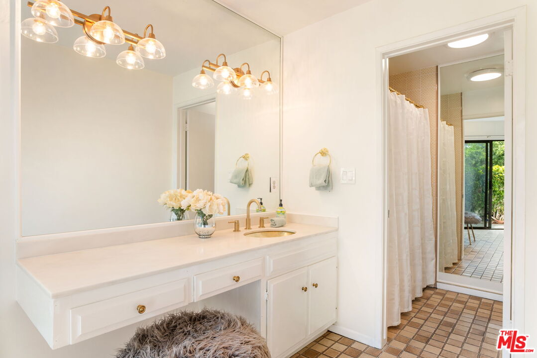 2829 Bottlebrush Drive Los Angeles, CA 90077 - Photo 17 of 40 a bathroom with a sink a vanity and a mirror