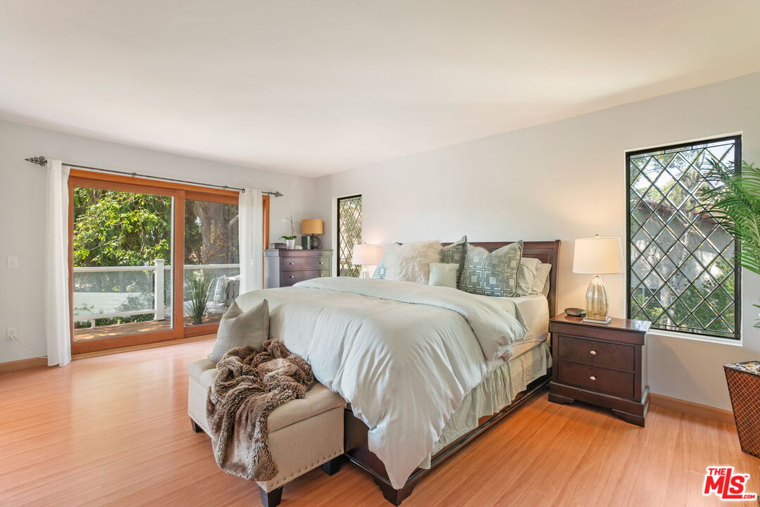 2829 Bottlebrush Drive Los Angeles, CA 90077 - Photo 18 of 40 a spacious bedroom with a bed and wooden floor