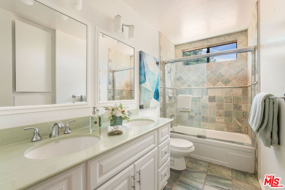 2829 Bottlebrush Drive Los Angeles, CA 90077 - Photo 21 of 40 a bathroom with a granite countertop sink toilet and shower