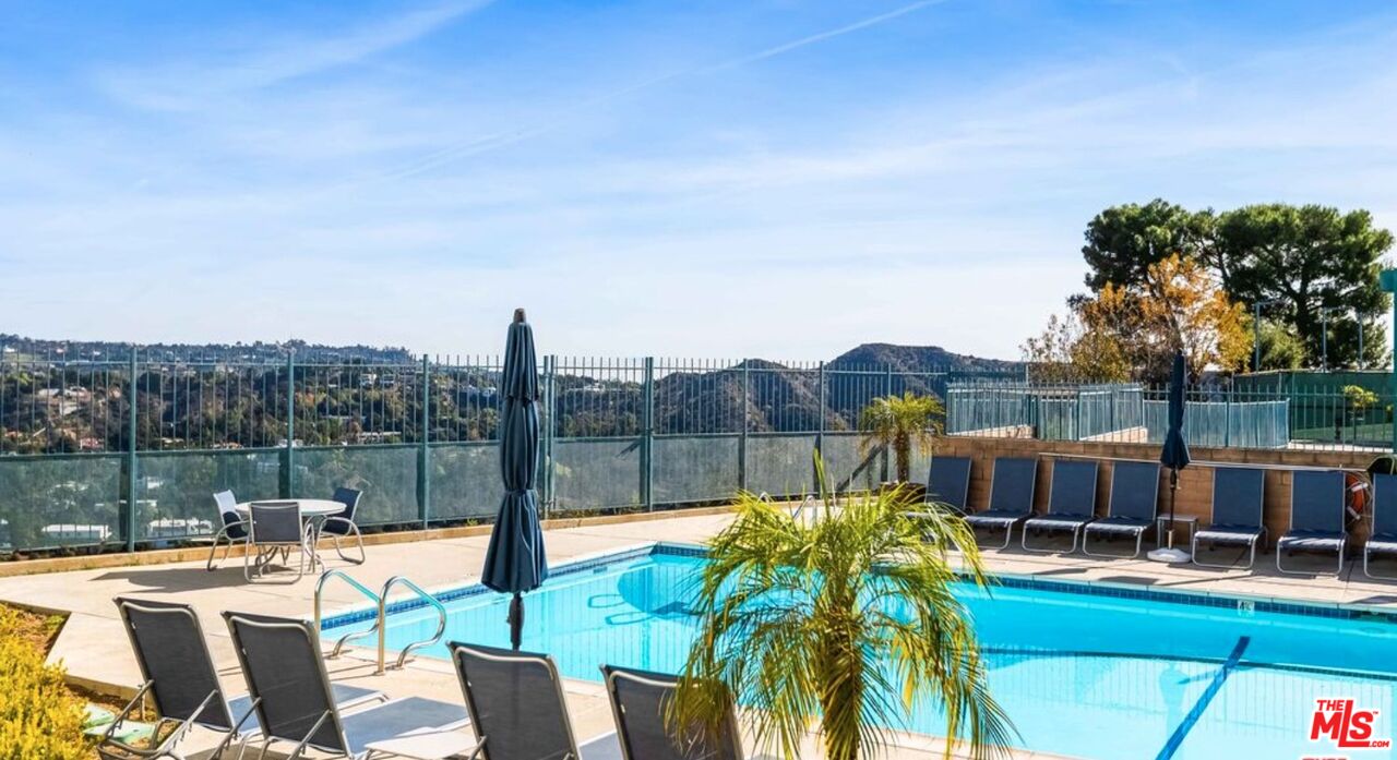 2829 Bottlebrush Drive Los Angeles, CA 90077 - Photo 34 of 40 a view of a patio with couches table and chairs next to a yard