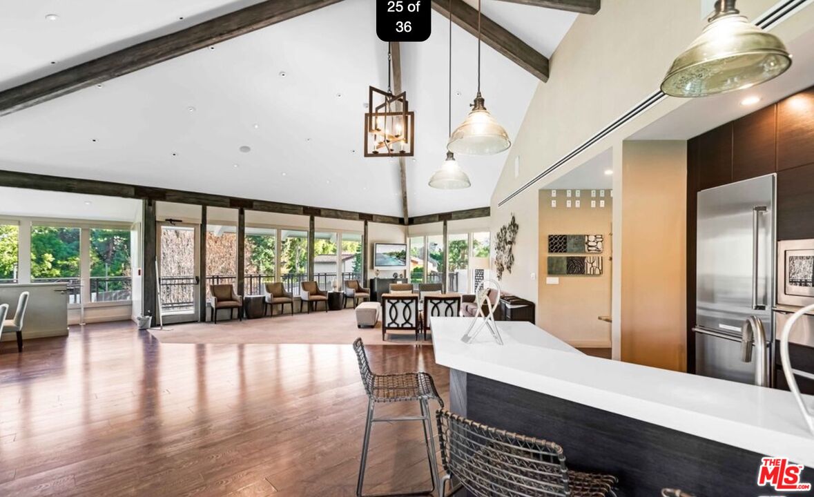 2829 Bottlebrush Drive Los Angeles, CA 90077 - Photo 40 of 40 a view of a dining room with furniture large windows and wooden floor