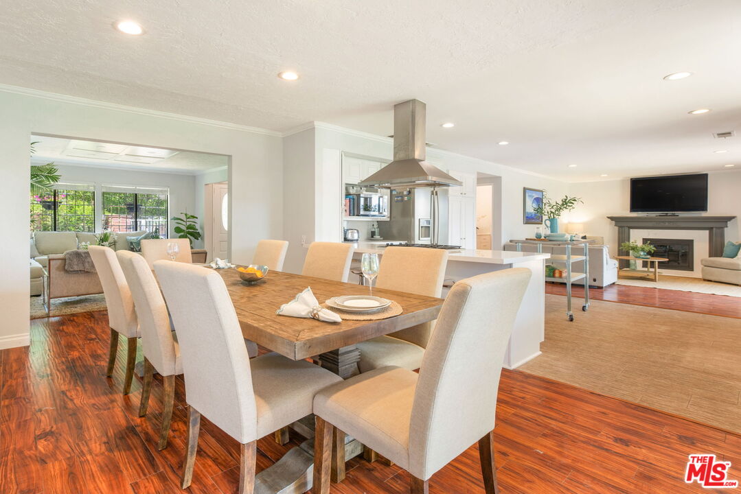 2829 Bottlebrush Drive Los Angeles, CA 90077 - Photo 9 of 40 a view of a dining room with furniture a chandelier and wooden floor