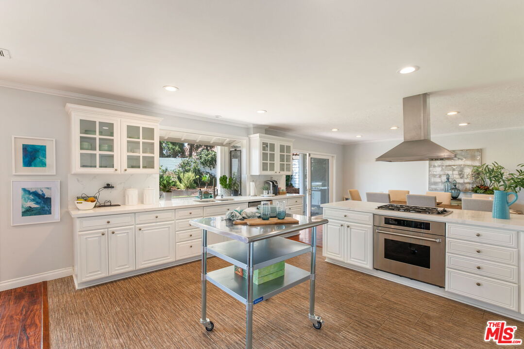 2829 Bottlebrush Drive Los Angeles, CA 90077 - Photo 10 of 40 a kitchen with stainless steel appliances granite countertop a stove and cabinets